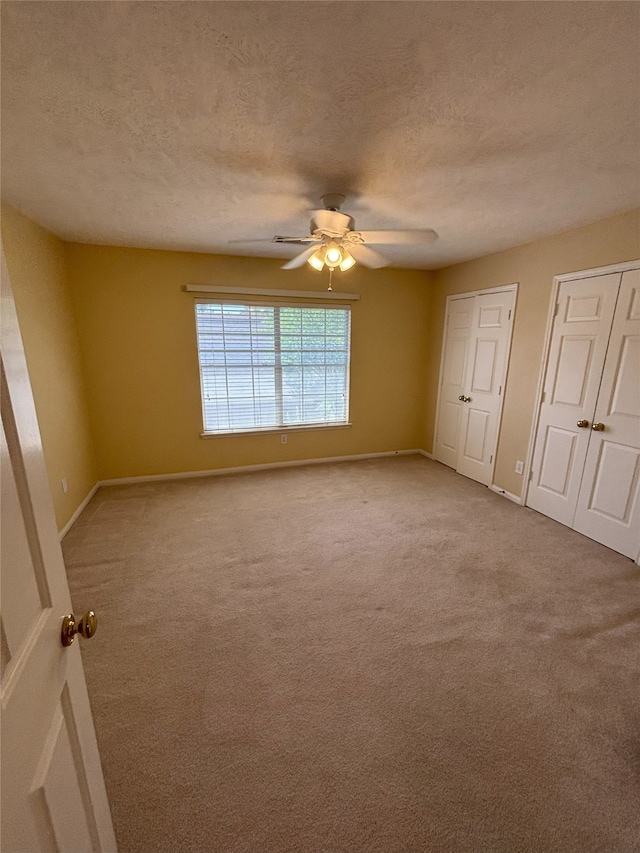 20003 Powerscourt Dr, Humble, TX 77346 - carpeted empty room featuring baseboards, ceiling fan, and a textured ceiling