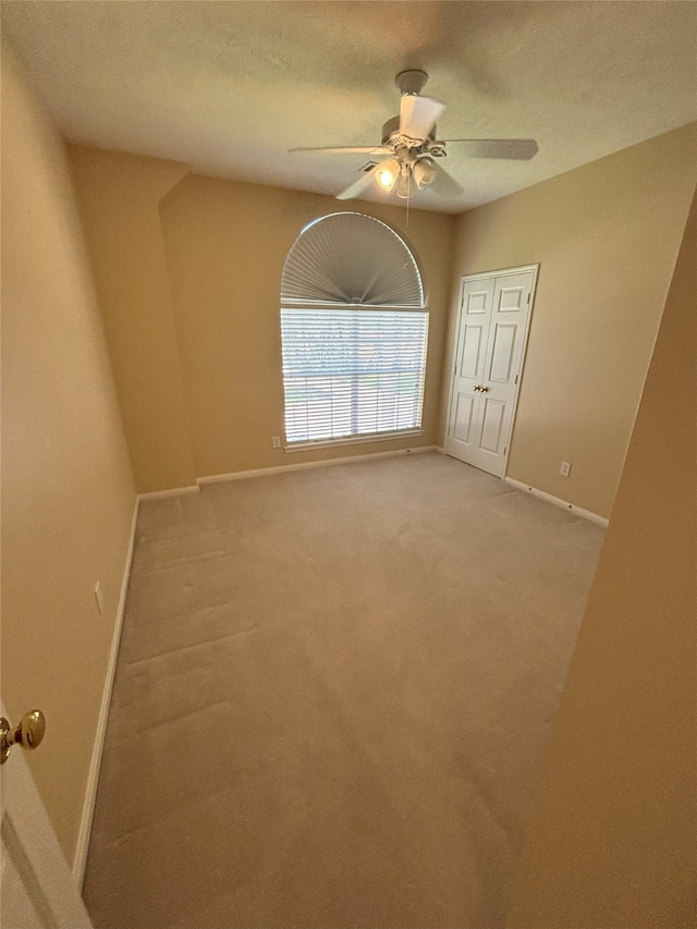 20003 Powerscourt Dr, Humble, TX 77346 - spare room featuring baseboards, a ceiling fan, and light carpet