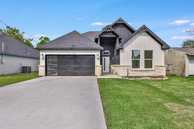 1107 N Main St, Dayton, TX 77535 - view of front facade with an attached garage, driveway, a front yard, roof with shingles, and central air condition unit