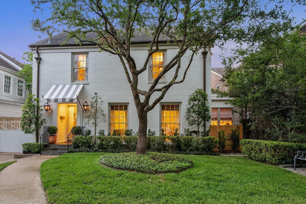 2736 Werlein Ave, West University Place, TX 77005 - colonial inspired home featuring a front yard and brick siding