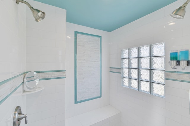 full bath with a tile shower and plenty of natural light