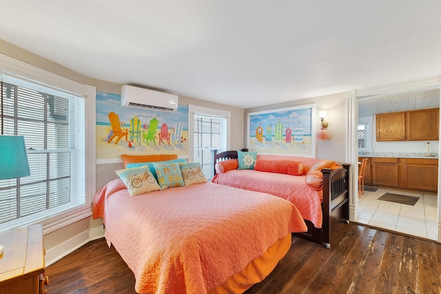 bedroom with a wall unit AC, hardwood / wood-style floors, and multiple windows