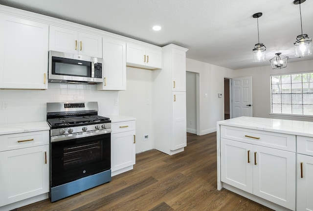 6002 Redfish Run, Baytown, TX 77523 - kitchen with appliances with stainless steel finishes, decorative backsplash, white cabinetry, dark wood-style floors, and recessed lighting