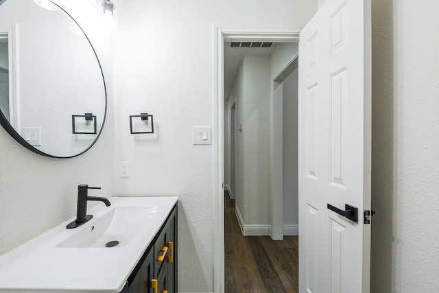 6002 Redfish Run, Baytown, TX 77523 - bathroom with wood finished floors, vanity, and baseboards