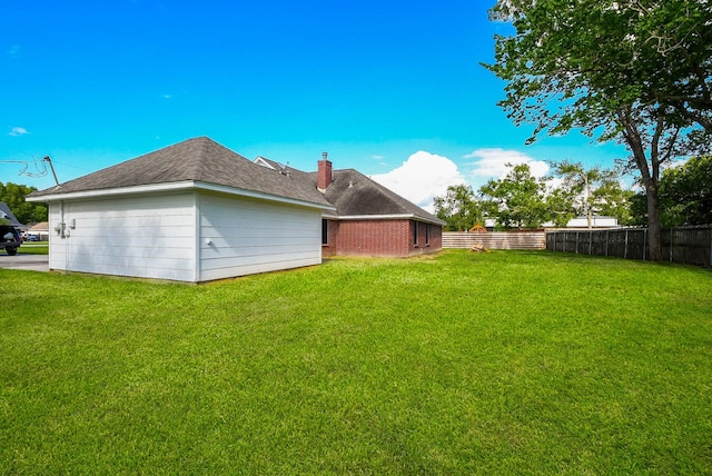 6002 Redfish Run, Baytown, TX 77523 - back of house with a chimney and roof with shingles
