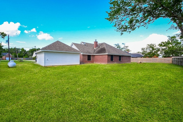 6002 Redfish Run, Baytown, TX 77523 - back of house with a chimney, brick siding, and roof with shingles