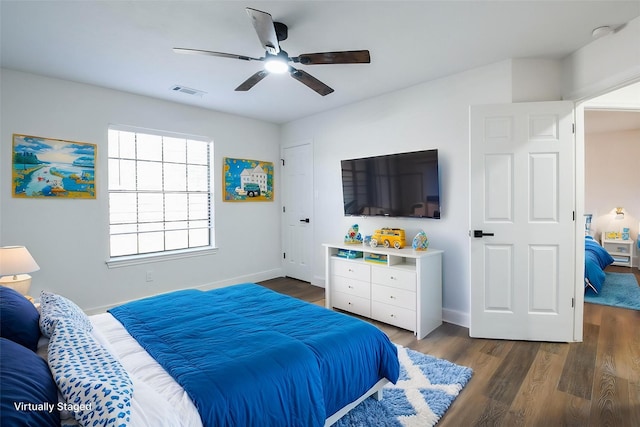 6002 Redfish Run, Baytown, TX 77523 - bedroom featuring dark wood-style floors, baseboards, and a ceiling fan