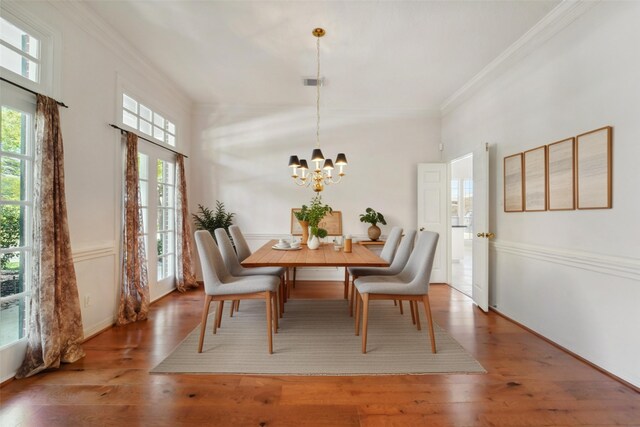 1706 Lofty Maple Trl, Houston, TX 77345 - dining area featuring ornamental molding, a chandelier, and wood finished floors