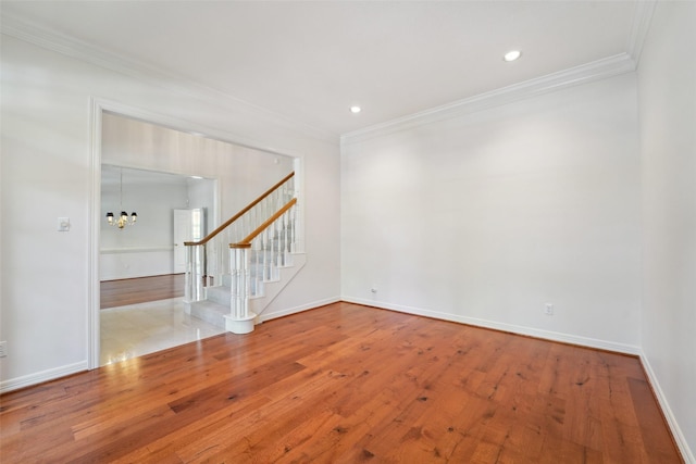 1706 Lofty Maple Trl, Houston, TX 77345 - spare room with ornamental molding, stairs, a chandelier, wood finished floors, and baseboards