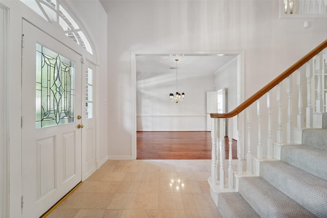 1706 Lofty Maple Trl, Houston, TX 77345 - foyer entrance featuring stairs, a chandelier, baseboards, and a high ceiling