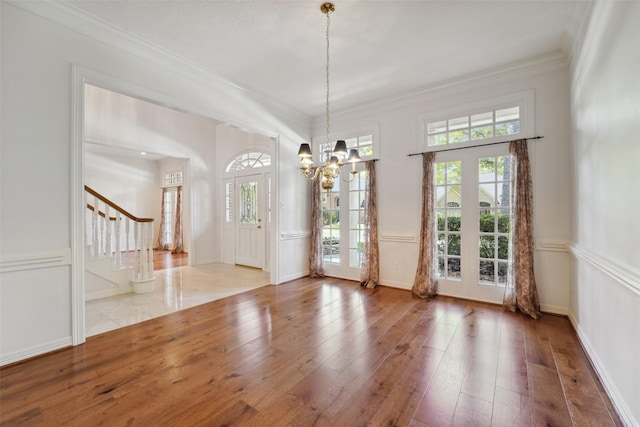 1706 Lofty Maple Trl, Houston, TX 77345 - unfurnished dining area featuring stairway, a chandelier, healthy amount of natural light, wood-type flooring, and crown molding
