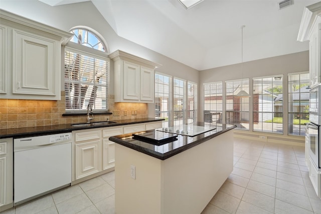1706 Lofty Maple Trl, Houston, TX 77345 - kitchen with white appliances, a sink, light tile patterned floors, plenty of natural light, and lofted ceiling
