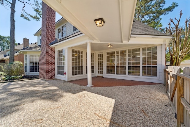 1706 Lofty Maple Trl, Houston, TX 77345 - back of property with a patio, a shingled roof, and fence