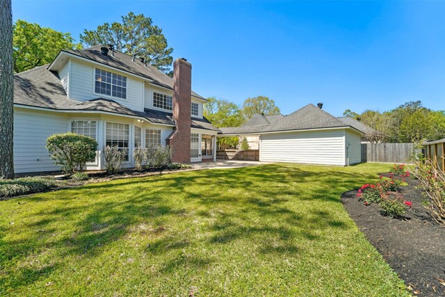 1706 Lofty Maple Trl, Houston, TX 77345 - back of house featuring a patio area and a chimney