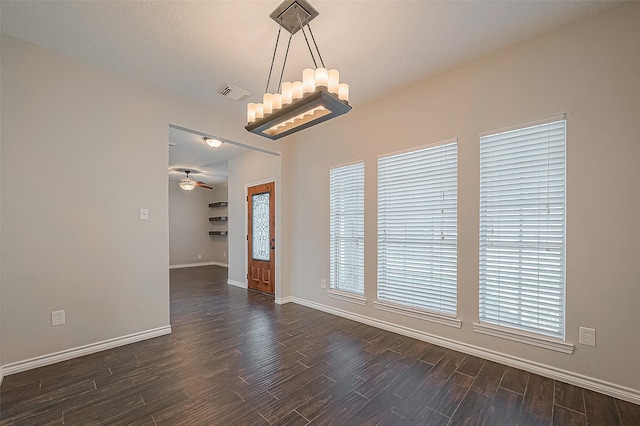 23123 Sandpiper Trl, Spring, TX 77373 - empty room featuring dark wood-style floors, baseboards, a chandelier, and ceiling fan