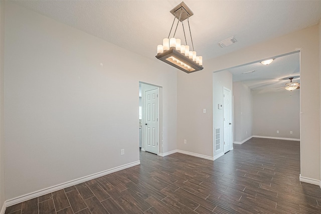 23123 Sandpiper Trl, Spring, TX 77373 - spare room with dark wood-style flooring, a ceiling fan, baseboards, and a chandelier