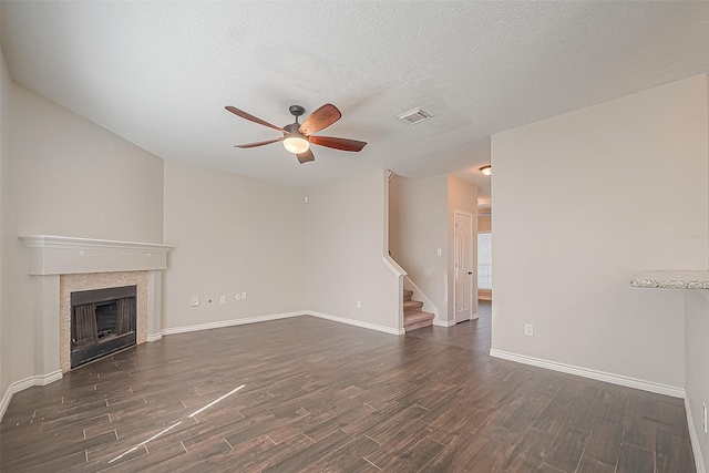 23123 Sandpiper Trl, Spring, TX 77373 - unfurnished living room featuring a ceiling fan, dark wood-type flooring, baseboards, stairway, and a fireplace