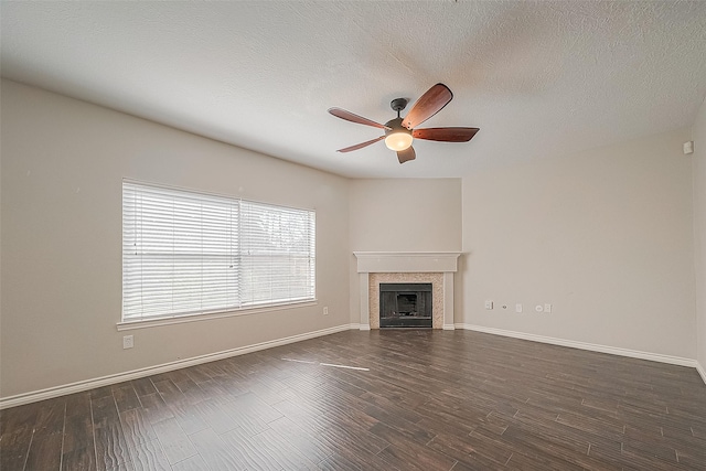 23123 Sandpiper Trl, Spring, TX 77373 - unfurnished living room featuring ceiling fan, a tile fireplace, dark wood-style floors, baseboards, and a textured ceiling