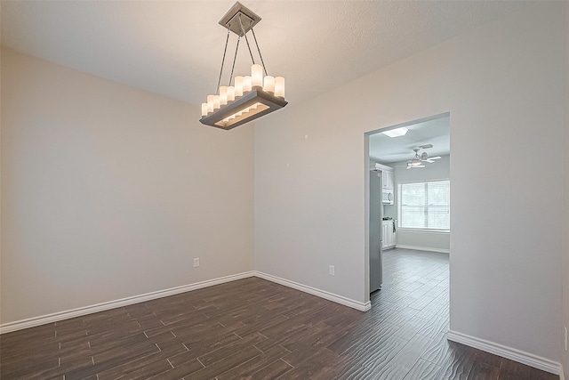 23123 Sandpiper Trl, Spring, TX 77373 - spare room with dark wood-style floors, baseboards, a chandelier, and a ceiling fan