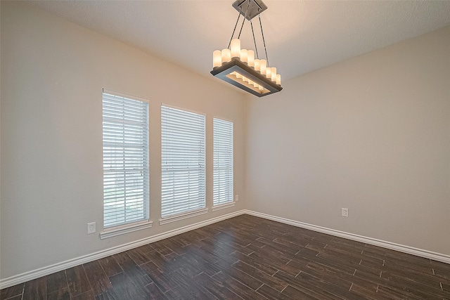 23123 Sandpiper Trl, Spring, TX 77373 - unfurnished room featuring a chandelier, dark wood-type flooring, and baseboards