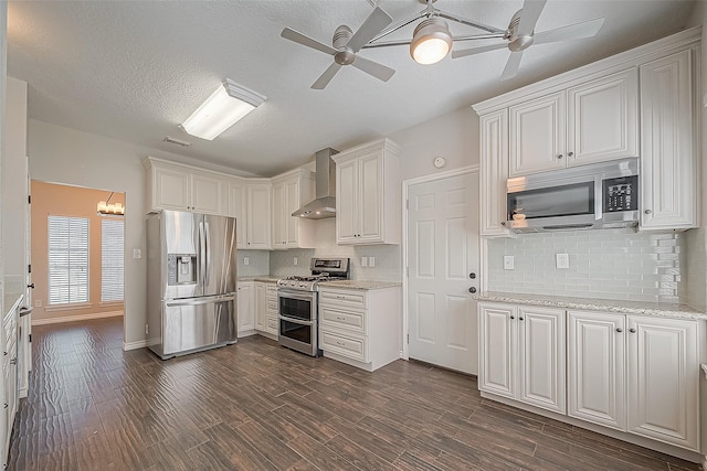 23123 Sandpiper Trl, Spring, TX 77373 - kitchen with appliances with stainless steel finishes, wall chimney range hood, a ceiling fan, dark wood-style floors, and a textured ceiling