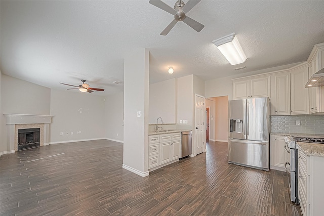 23123 Sandpiper Trl, Spring, TX 77373 - kitchen with stainless steel appliances, ceiling fan, tasteful backsplash, dark wood-type flooring, and open floor plan