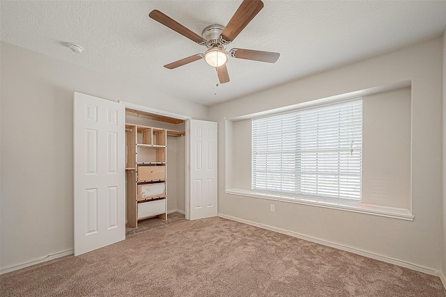 23123 Sandpiper Trl, Spring, TX 77373 - unfurnished bedroom with light carpet, baseboards, a ceiling fan, a textured ceiling, and a closet