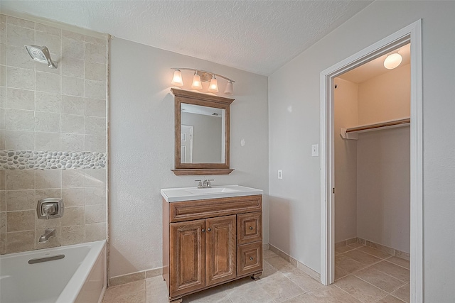 23123 Sandpiper Trl, Spring, TX 77373 - full bath with a tub, vanity, tile patterned flooring, a textured ceiling, and baseboards