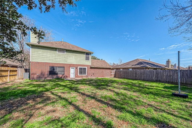 23123 Sandpiper Trl, Spring, TX 77373 - rear view of house with brick siding, a chimney, and central AC