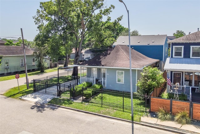 view of front of property featuring a residential view, a porch, and a gate
