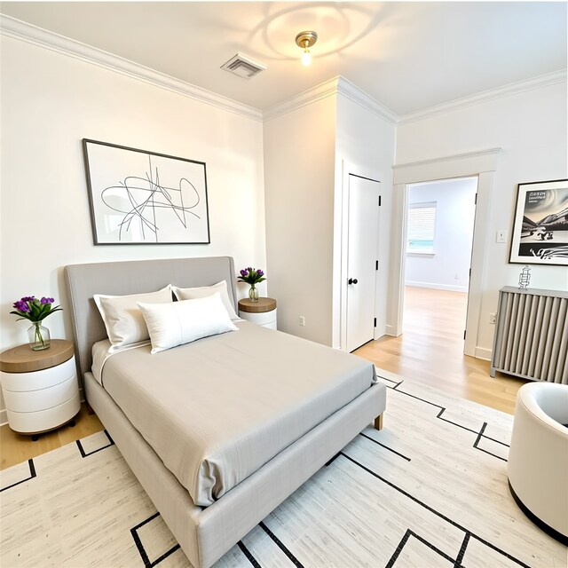 301 Tabor St, Houston, TX 77009 - bedroom with ornamental molding, light wood finished floors, and baseboards