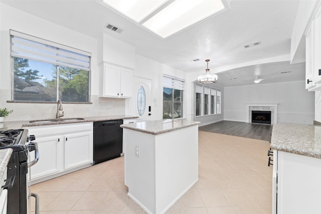 20415 Longspring Dr, Katy, TX 77450 - kitchen with dishwasher, a sink, a fireplace, and light tile patterned floors