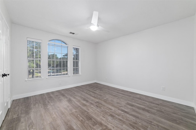20415 Longspring Dr, Katy, TX 77450 - spare room with dark wood-style floors, a ceiling fan, and baseboards