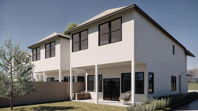 rear view of property with a patio area and fence