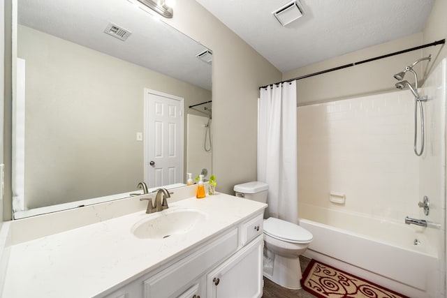 bathroom with shower / bath combo with shower curtain, toilet, and vanity