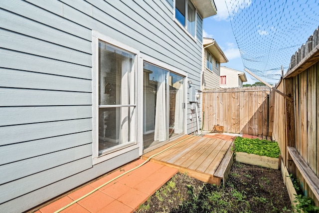 view of patio featuring fence and a deck