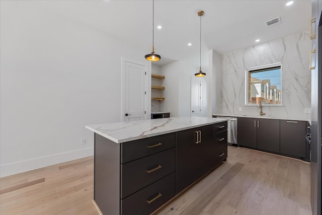 3914 Tulane St, Houston, TX 77018 - kitchen with dishwasher, light wood-style flooring, a center island, a sink, and decorative light fixtures