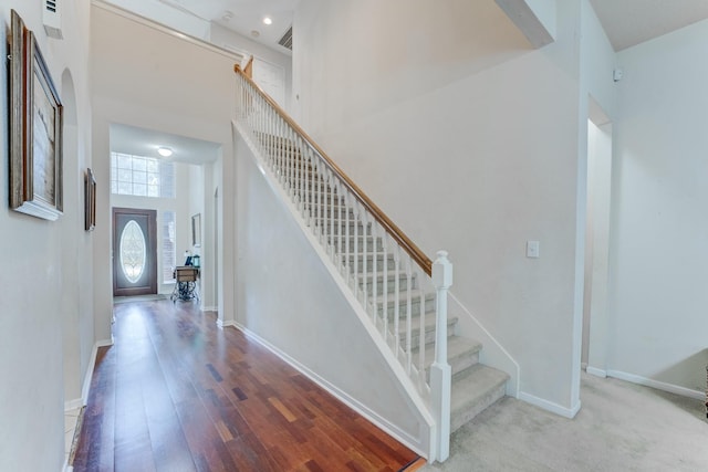 515 Deer Hollow Dr, Sugar Land, TX 77479 - staircase with wood finished floors, a towering ceiling, and baseboards