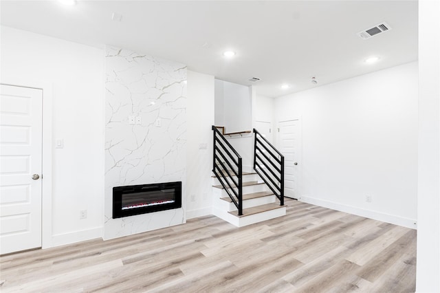 610 E 41st St Unit A B, Houston, TX 77022 - below grade area with wood finished floors, recessed lighting, a premium fireplace, stairs, and baseboards