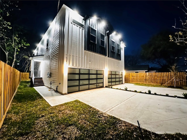 610 E 41st St Unit A B, Houston, TX 77022 - property exterior at twilight with an attached garage, fence, and concrete driveway