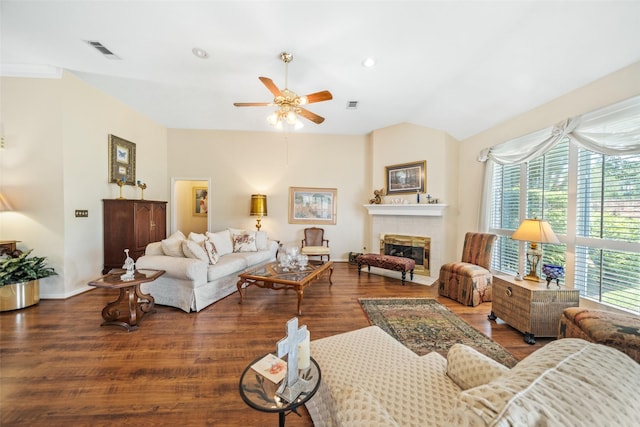 12938 Quail Park Dr, Cypress, TX 77429 - living room featuring ceiling fan, wood finished floors, a tiled fireplace, vaulted ceiling, and baseboards