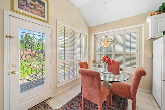 12938 Quail Park Dr, Cypress, TX 77429 - dining space with a chandelier, vaulted ceiling, light tile patterned floors, and baseboards
