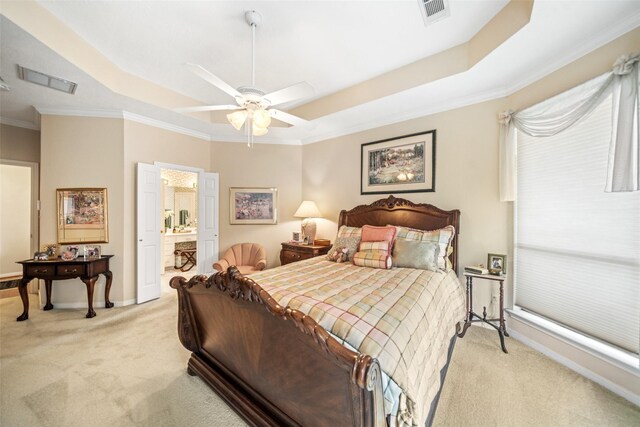 12938 Quail Park Dr, Cypress, TX 77429 - bedroom featuring a raised ceiling, light carpet, crown molding, baseboards, and ensuite bath
