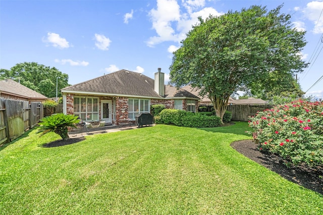 12938 Quail Park Dr, Cypress, TX 77429 - rear view of house featuring a chimney, a patio, and brick siding