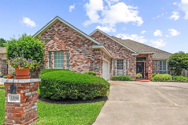 12938 Quail Park Dr, Cypress, TX 77429 - view of front facade featuring brick siding, an attached garage, concrete driveway, and roof with shingles