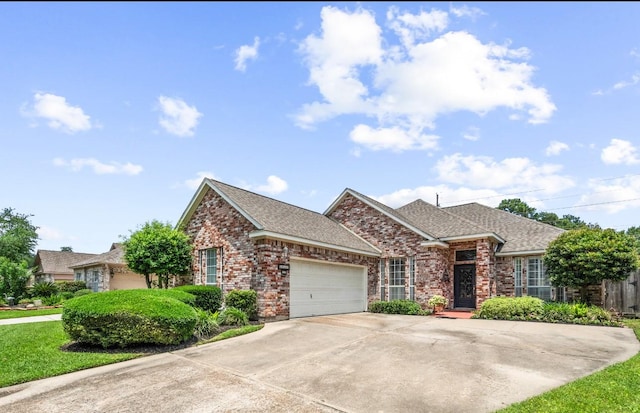 12938 Quail Park Dr, Cypress, TX 77429 - view of front facade with brick siding, an attached garage, roof with shingles, and concrete driveway