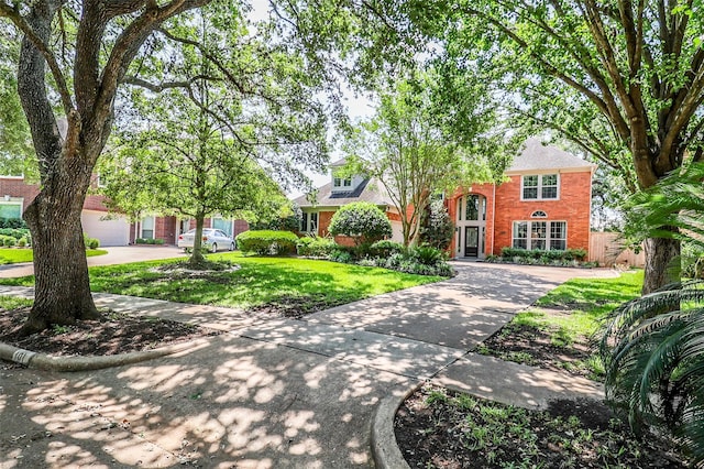 101 N Hall Dr, Sugar Land, TX 77478 - view of front facade featuring brick siding, driveway, and a front lawn