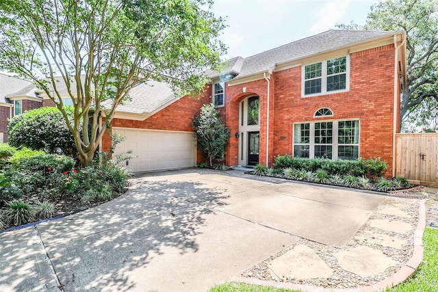 101 N Hall Dr, Sugar Land, TX 77478 - traditional home featuring brick siding, concrete driveway, fence, and an attached garage