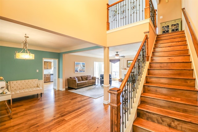 101 N Hall Dr, Sugar Land, TX 77478 - stairs with wood finished floors, crown molding, a ceiling fan, and baseboards
