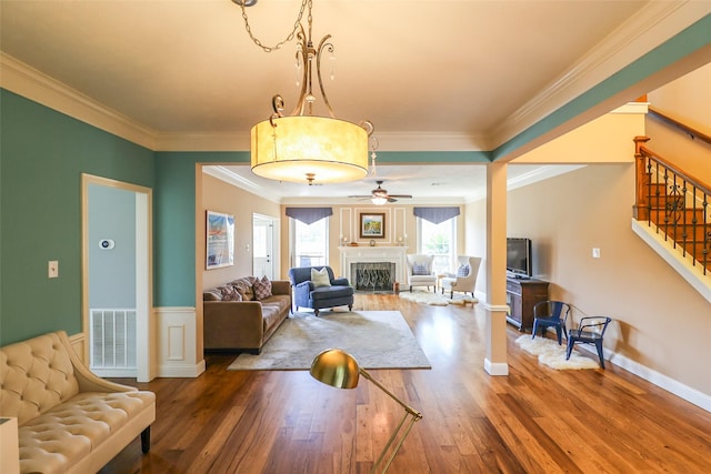101 N Hall Dr, Sugar Land, TX 77478 - living room featuring wood finished floors, stairway, a ceiling fan, a fireplace, and crown molding